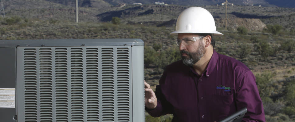 UniSource employe looking over AC unit