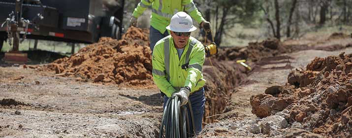 UniSource Gas worker in trench installing new pipe.